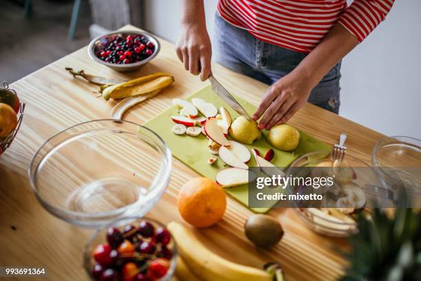 girl preparing fruit salad - fruit salad stock pictures, royalty-free photos & images