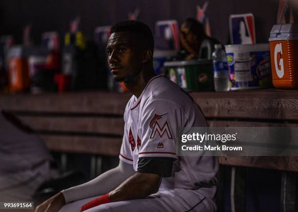 Lewis Brinson of the Miami Marlins looks on in the dugout during the game against the Tampa Bay Rays at Marlins Park on July 3, 2018 in Miami,...