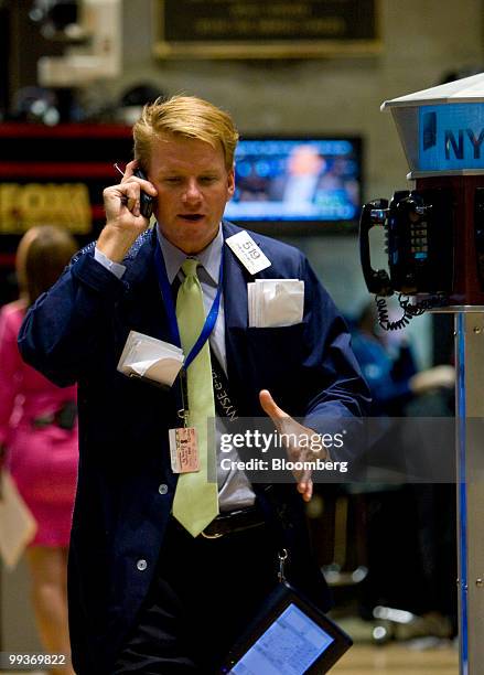 Trader talks on a telephone while working on the floor of the New York Stock Exchange in New York, U.S., on Friday, May 14, 2010. U.S. Stocks fell...