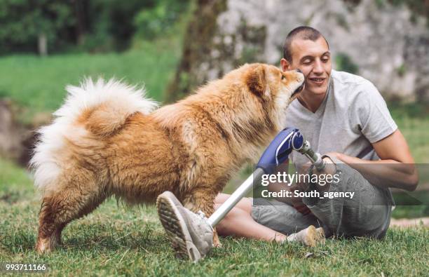 disability guy and pet love - white chow chow stock pictures, royalty-free photos & images