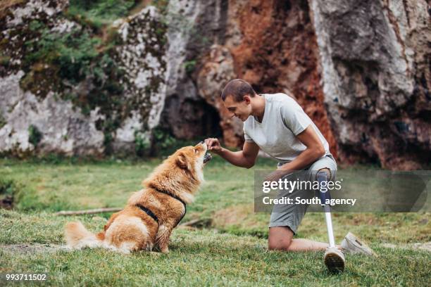 disability man and chow dog - white chow chow stock pictures, royalty-free photos & images