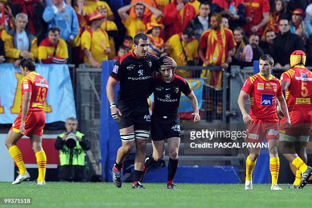 Toulouse's scrum-half Nicolas Bezy is congratulated by team-mate after scoring a try during the French Top 14 rugby union semi-final match Toulouse...
