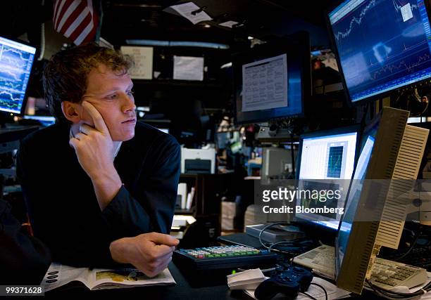 Trader looks at a monitor while working on the floor of the New York Stock Exchange in New York, U.S., on Friday, May 14, 2010. U.S. Stocks fell for...