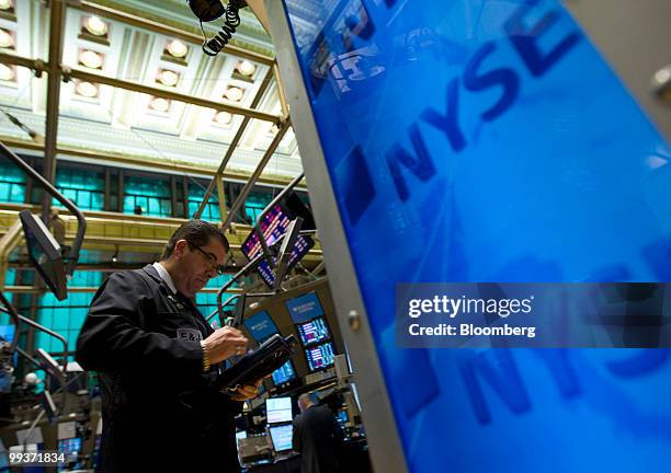 Traders work on the floor of the New York Stock Exchange in New York, U.S., on Friday, May 14, 2010. U.S. Stocks fell for a second day, pushing the...