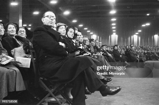 American evangelist Billy Graham addressing a huge crowd of people at Kelvin Hall in Glasgow, Scotland during his Scottish Crusade, 23rd March 1955.