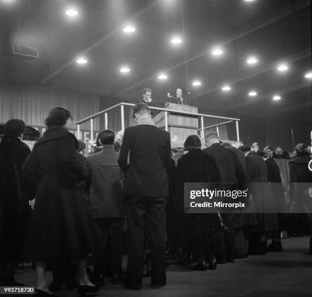 American evangelist Billy Graham addressing a huge crowd of people at Kelvin Hall in Glasgow, Scotland during his Scottish Crusade, 23rd March 1955.