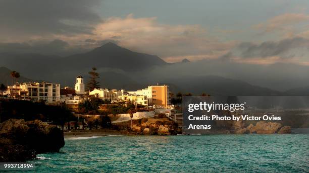 village of nerja and the balcon de europa viewpoint at sunset in malaga - balcon stock pictures, royalty-free photos & images