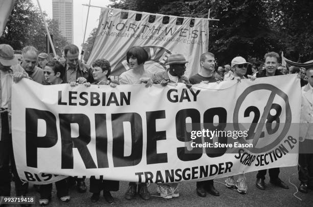 Celebrities help to hold a banner opposing Section 28, at the Lesbian, Gay, Bisexual, and Transgender Pride event, London, 4th July 1998. Those...