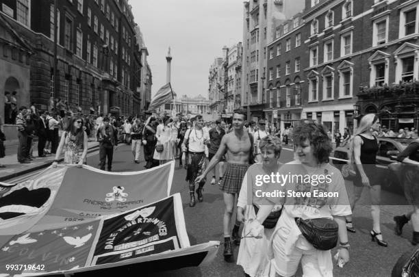 Marchers carrying a contribution to the NAMES Project AIDS Memorial Quilt, at the Lesbian and Gay Pride event, Whitehall, London, 18th June 1994.