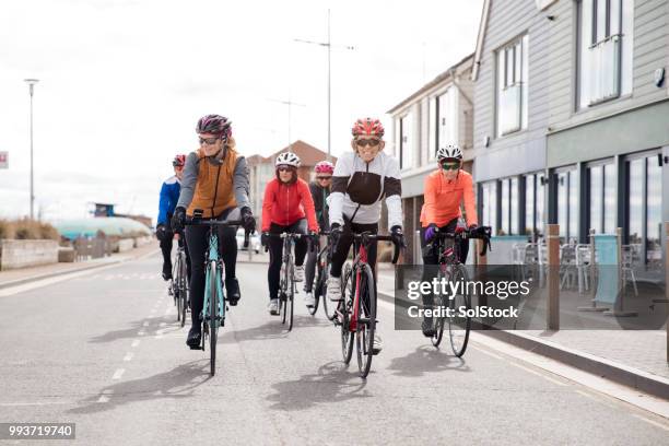 cyclists on the road - girl power expressão inglesa imagens e fotografias de stock