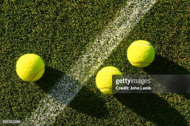 tennis balls on grass court - grass court stock pictures, royalty-free photos & images