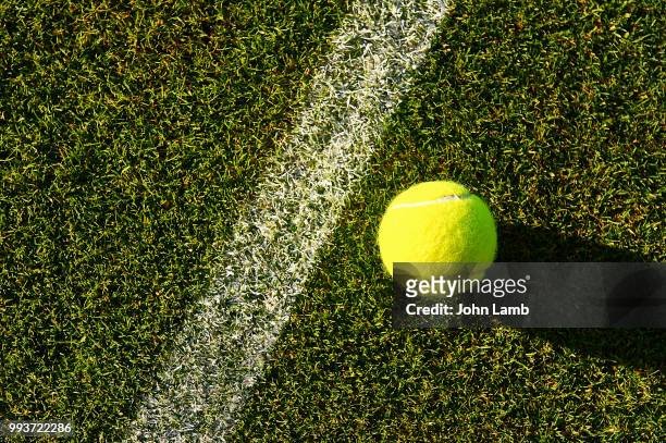 tennis ball on grass court - wimbledon tennis stock pictures, royalty-free photos & images