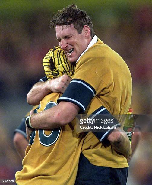 Elton Flatley embraces teammate Justin Harrison of the Wallabies after victory over the Lions during the third Test Match between the Australian...