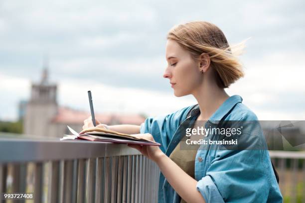 a young attractive woman of 20 years draws in a sketchbook - 20 24 years photos stock pictures, royalty-free photos & images