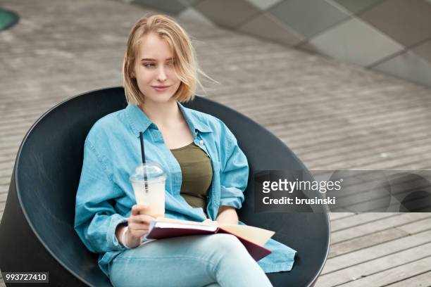 a young attractive woman of 20 years draws in a sketchbook - 20 24 years stock pictures, royalty-free photos & images