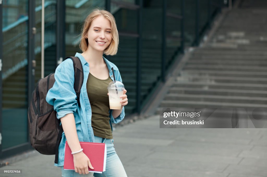 Portrait of a young attractive female student 20 years old with a backpack