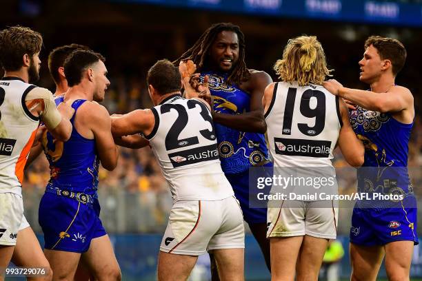 Nick Haynes of the Giants wrestles with Nic Naitanui of the Eagles during the 2018 AFL round 16 match between the West Coast Eagles and the GWS...