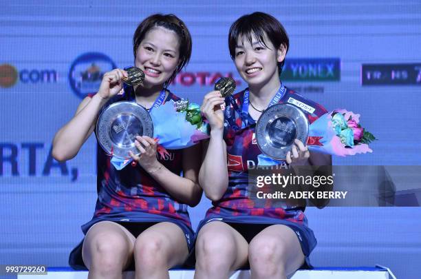 Yuki Fukushima and Sayaka Hirota of Japan pose after winning the women's doubles badminton final match against Mayu Matsumoto and and Wakana Nagahara...