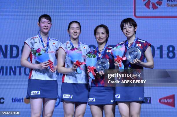 Runner up Mayu Matsumoto and Wakana Nagahara of Japan pose with Yuki Fukushima and Sayaka Hirota of Japan after the women's doubles badminton final...