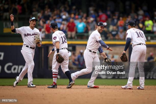 Christian Yelich, Eric Sogard, Ryan Braun, and Brad Miller of the Milwaukee Brewers celebrate after beating the Minnesota Twins 3-2 at Miller Park on...