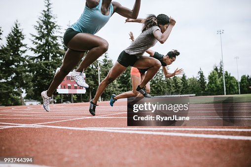 Woman Athletes At Race Starting Line Ready to Run Woman Athletes At Race Starting Line Ready to Run