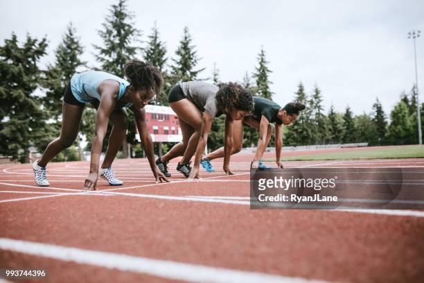 kvinna idrottare på race startlinjen redo att springa - spikskor för löpning bildbanksfoton och bilder