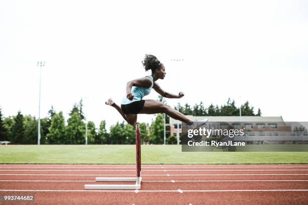 vrouw atleet loopt horden voor track &amp; field - hordelopen atletiekonderdeel stockfoto's en -beelden