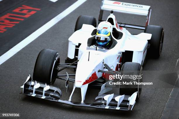 Santander UK ambassador Jenson Button takes British motorcycle legend Guy Martin for a lap of the 2018 F1 British Grand Prix at Silverstone Circuit...