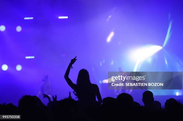 People attend US singer Rick Ross concert during the 30th Eurockeennes rock music festival on July 7, 2018 in Belfort, eastern France.