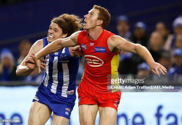 Rory Thompson of the Suns in his 100th game and Ben Brown of the Kangaroos compete for the ball during the 2018 AFL round 16 match between the North...