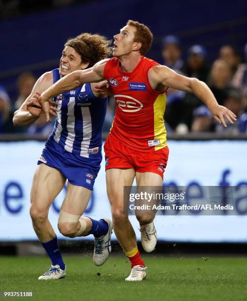 Rory Thompson of the Suns in his 100th game and Ben Brown of the Kangaroos compete for the ball during the 2018 AFL round 16 match between the North...