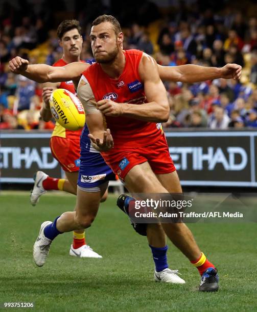 Jarrod Witts of the Suns handpasses the ball during the 2018 AFL round 16 match between the North Melbourne Kangaroos and the Gold Coast Suns at...