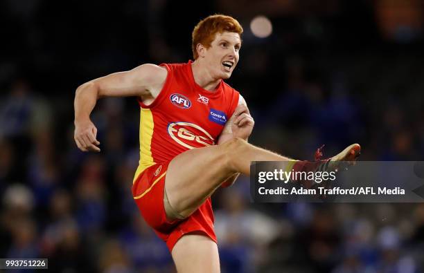 Josh Schoenfeld of the Suns kicks the ball during the 2018 AFL round 16 match between the North Melbourne Kangaroos and the Gold Coast Suns at Etihad...