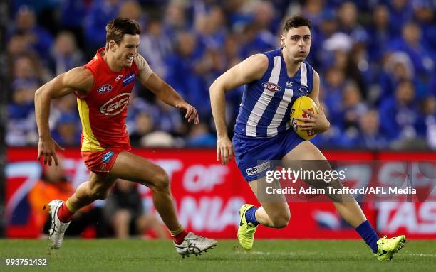 Paul Ahern of the Kangaroos in action ahead of Jarryd Lyons of the Suns during the 2018 AFL round 16 match between the North Melbourne Kangaroos and...