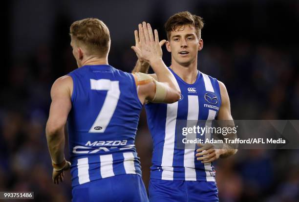 Shaun Atley of the Kangaroos congratulates Jack Ziebell of the Kangaroos on a goal during the 2018 AFL round 16 match between the North Melbourne...