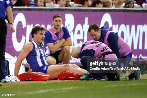 Cameron Zurhaar of the Kangaroos is seen injured during the 2018 AFL round 16 match between the North Melbourne Kangaroos and the Gold Coast Suns at...