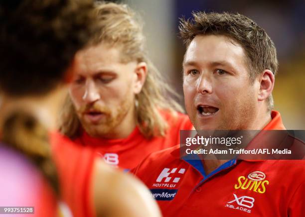 Stuart Dew, Senior Coach of the Suns addresses his players during the 2018 AFL round 16 match between the North Melbourne Kangaroos and the Gold...