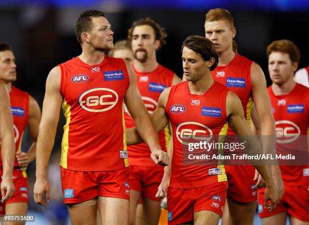 Steven May and Sean Lemmens of the Suns look dejected after a loss during the 2018 AFL round 16 match between the North Melbourne Kangaroos and the...