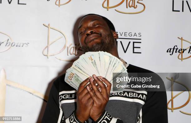 Meek Mill fans out a stack of USD 100 bills as he arrives for the debut of his residency at Drai's Beach Club - Nightclub at The Cromwell Las Vegas...