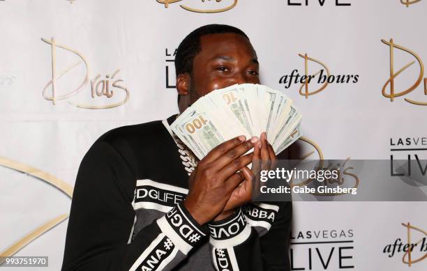 Meek Mill hides behind a stack of USD 100 bills as he arrives for the debut of his residency at Drai's Beach Club - Nightclub at The Cromwell Las...