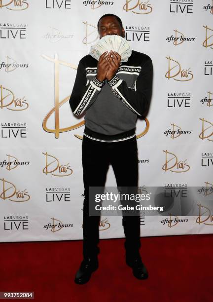 Meek Mill fans out a stack of USD 100 bills as he arrives for the debut of his residency at Drai's Beach Club - Nightclub at The Cromwell Las Vegas...