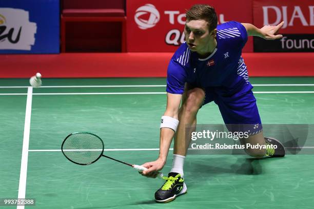 Viktor Axelsen of Denmark competes against Kento Momota of Japan during the Men's Singles Final match on day six of the Blibli Indonesia Open at...