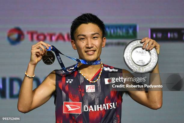 Gold medalist Kento Momota of Japan celebrates on the podium after winning the Men's Singles Final match on day six of the Blibli Indonesia Open at...