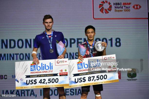 Silver medalist Viktor Axelsen of Denmark and gold medalist Kento Momota of Japan pose on the podium during the Men's Singles awarding ceremony on...