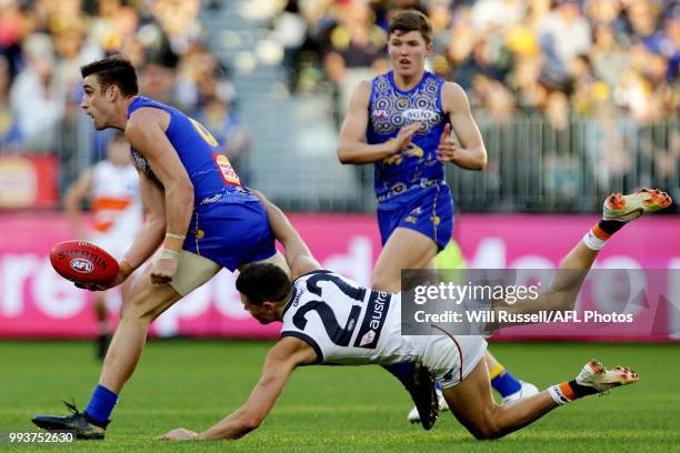 Elliot Yeo of the Eagles is tackled by Josh Kelly of the Giants during the round 16 AFL match between the West Coast Eagles and the Greater Western...