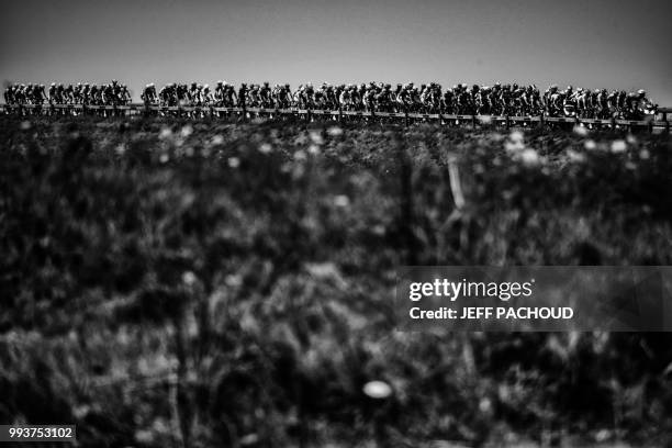 The pack rides during the first stage of the 105th edition of the Tour de France cycling race between Noirmoutier-en-l'ile and Fontenay-le Comte,...