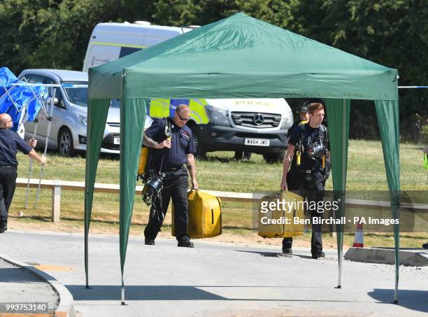 Fire crews carry equipment to the scene on Muggleton Road in Amesbury, Wiltshire, where counter-terrorism officers are investigating after a couple...