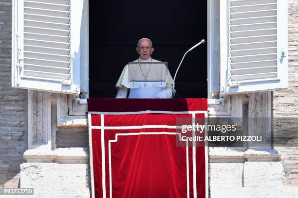 Pope Francis addresses the crowd from the window of the Apostolic Palace overlooking St.Peter's square during his Angelus prayer on July 8, 2018 at...