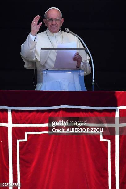 Pope Francis addresses the crowd from the window of the Apostolic Palace overlooking St.Peter's square during his Angelus prayer on July 8, 2018 at...