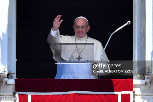 Pope Francis addresses the crowd from the window of the Apostolic Palace overlooking St.Peter's square during his Angelus prayer on July 8, 2018 at...